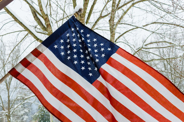 American Flag with winter snow background. Celebration national USA Holiday and patriotic pride.