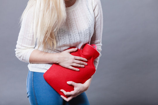 Woman Feeling Stomach Cramps Holding Hot Water Bottle