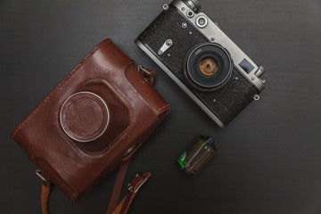 Vintage Film Camera And Roll On Black Wooden Background Technology Development Photographer...