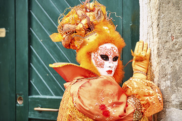 Fototapeta premium Venice carnival: 2017. Carnival mask. Venice, Itali. Orange carnival costume in Venice