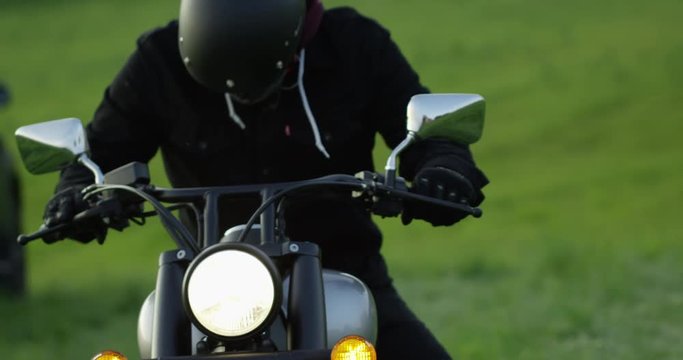 Motorcycle rider gets on motorcycle - slow motion