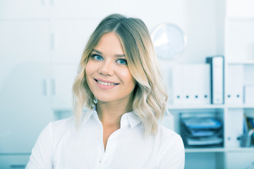 Kindness girl in white shirt in modern office close-up