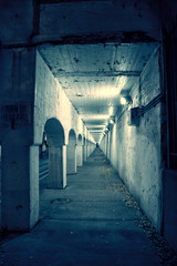 Obraz premium Gritty dark Chicago city street with industrial train bridge viaduct tunnel at night.