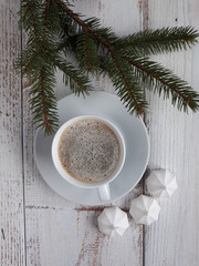 a cup of coffee and small meringues
