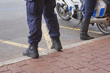 Feet of the police stand on the sidewalk. The police of Portugal on the protection of order on the...
