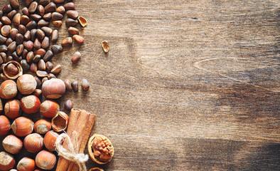 Different nuts on a wooden table. Cedar, cashew, hazelnut, walnu