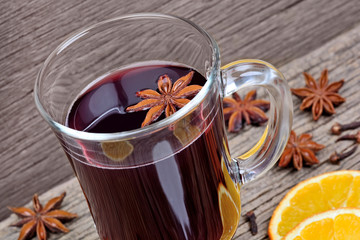 Mulled wine with spices in a glass on table