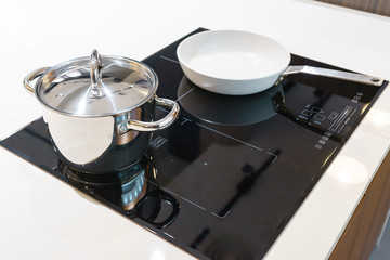 Metal Pot and pan on induction hob in modern kitchen. modern kitchen pot cooking induction...