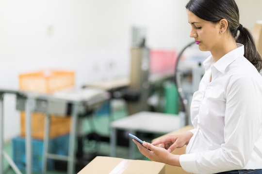 Female Warehouse Worker Checking Delivering Boxes. Distribution Center. Logistics Concept.