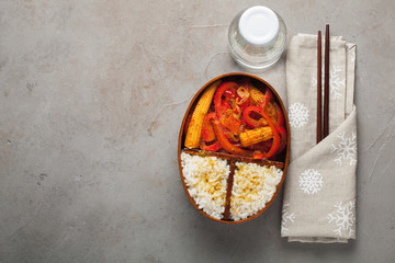 Wooden lunch boxe with healthy food ready to go for work or school, ahead meal preparation or dieting concept. On a old stone table with rust. Top view with copy space