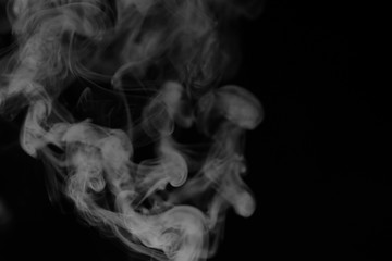 White smoke on a black background. Texture of smoke. Clubs of wh