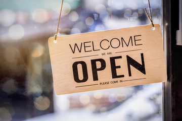 Wooden sign board hanging on door of cafe