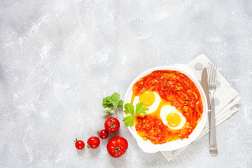 Tasty and Healthy Shakshuka in a Frying Pan. Eggs Poached in Spicy Tomato Pepper Sauce. Top view