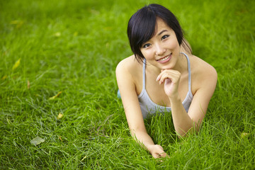 Naklejka na ściany i meble pretty young asian woman relax on grassland