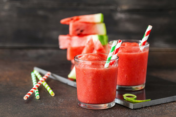 Glass of watermelon smoothie on a dark table. Selective focus