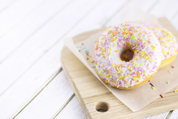 Donut on a wooden white background