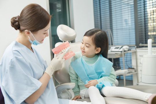 Cute little girl and dentist