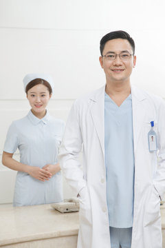 Men's doctors and young women nurses are at the reception desk