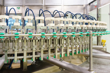 bottle filling, beverage bottles filled with beverage by an industrial machine in a beverage factory