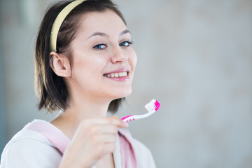 woman in the bathroom brushes teeth