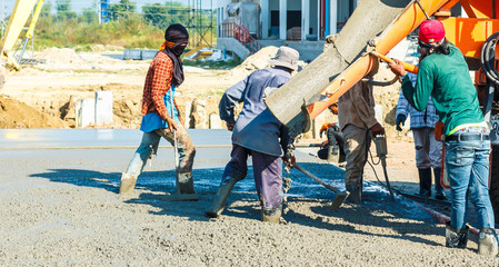 concreting work: construction site worker during concrete 
