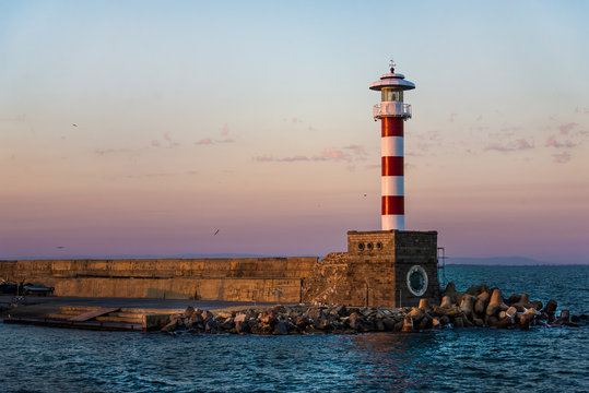 Fototapeta Colorful sunset over the lighthouse of the Bourgas sea shore