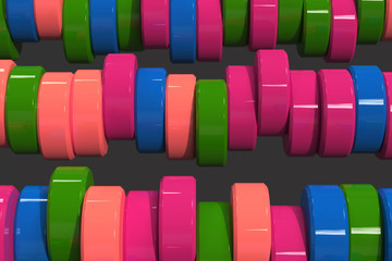 Pattern of blue, red and green cylinder tablets on black background