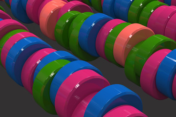 Pattern of blue, red and green cylinder tablets on black background