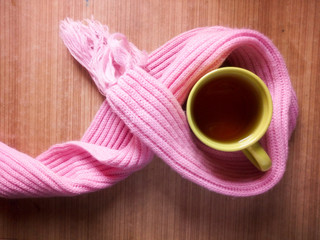 High angle view of cup of hot tea and woolen scarf on table