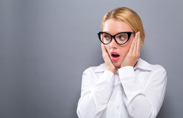 Surprised young woman posing on a solid background