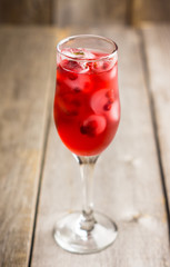 Tasty christmas cocktail with cranberry and foxberry. Shallow depth of field. Selective focus.