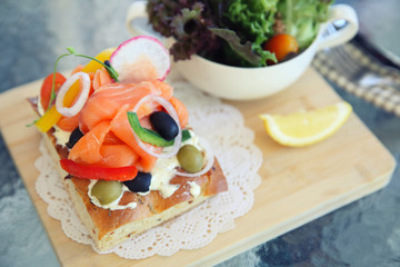 Fototapeta na wymiar Smoked salmon on toast with salad vegetable