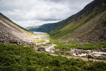 Fototapeta na wymiar A river flowing through Glendalough National Park in Ireland. 