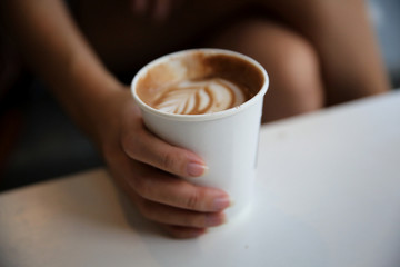 cappuccino coffee on woman hand