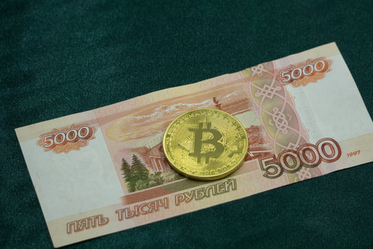 Coin Bitcoin against the background of Russian rubles .