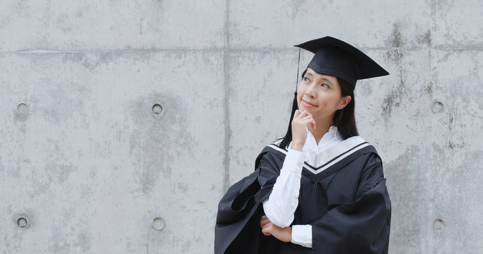 Woman graduation gown and think of future