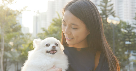 Young Woman being with her dog in the park