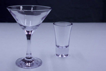 empty Martini glass stack on a lilac background .