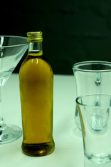 a bottle of whiskey with glasses near shooting .