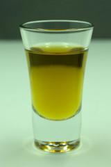 glass with a dark drink a pale background