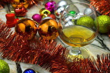 Fototapeta na wymiar glass and decorative Christmas balls Christmas garlands over glowing bokeh lights background