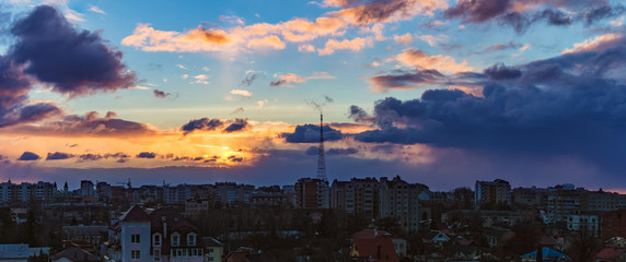 gold sunrise and dramatic sky over the city of Ivano-Frankivsk, Ukraine