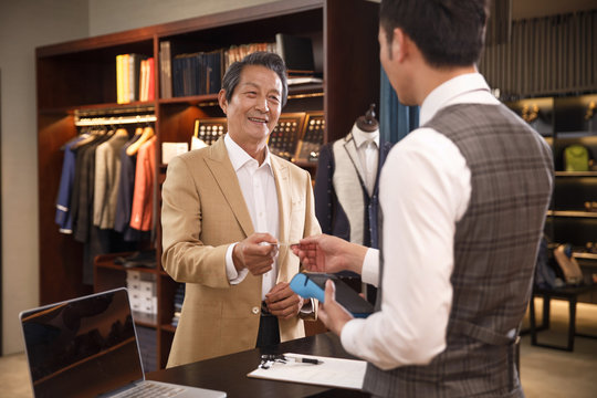 Fashion designers and customers at the checkout counter
