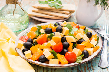 Greek salad with fresh vegetables on a wooden table
