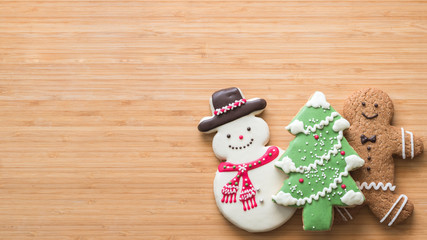Christmas cookies, snowman, tree, gingerbread flat lay on wooden cutting board background top view for Xmas party holiday food design decoration backdrop