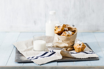 Fresh homemade cupcakes with raisins, powdered sugar and milk