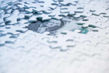 Missing jigsaw puzzle pieces on money dollar background, Business solution concept ,key for success