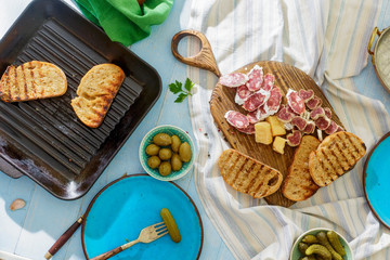Top view Italian snacks Bruschetta on blue wooden table