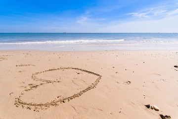 Love Heart drawn on sandy atlantic coast background.