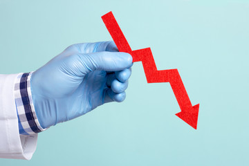 The doctor holds a red arrow in his hand, falls down. Indicators deteriorate, the fall is expected